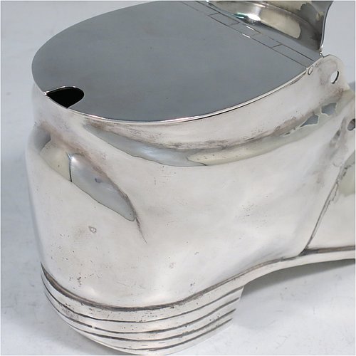 An Antique Victorian Silver Plated spoon warmer, in the shape of a leather shoe, having a hand-chased body with invisibly hinged lid opening, and all sitting on a hobnail boot base with heel. Made by Thomas Latham & Ernest Morton of Birmingham in ca. 1880. The dimensions of this fine hand-made silver-plated spoon warmer are length 16.5 cms (6.5 inches), height 9.5 cms (3.75 inches), and width 7 cms (2.75 inches).
