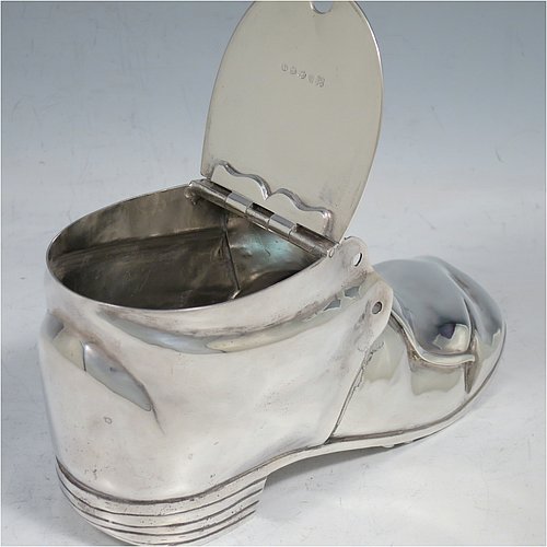 An Antique Victorian Silver Plated spoon warmer, in the shape of a leather shoe, having a hand-chased body with invisibly hinged lid opening, and all sitting on a hobnail boot base with heel. Made by Thomas Latham & Ernest Morton of Birmingham in ca. 1880. The dimensions of this fine hand-made silver-plated spoon warmer are length 16.5 cms (6.5 inches), height 9.5 cms (3.75 inches), and width 7 cms (2.75 inches).