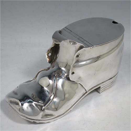 An Antique Victorian Silver Plated spoon warmer, in the shape of a leather shoe, having a hand-chased body with invisibly hinged lid opening, and all sitting on a hobnail boot base with heel. Made by Thomas Latham & Ernest Morton of Birmingham in ca. 1880. The dimensions of this fine hand-made silver-plated spoon warmer are length 16.5 cms (6.5 inches), height 9.5 cms (3.75 inches), and width 7 cms (2.75 inches).