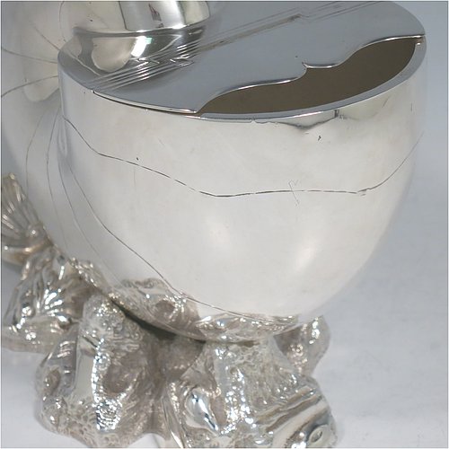 An Antique Victorian Silver Plated spoon warmer, in the shape of a Nautilus shell, having a hand-chased body with invisibly hinged lid opening, and all sitting on a cast rock base with shell thumb-piece. Made by the Atkin Brothers of Sheffield in ca. 1880. The dimensions of this fine hand-made silver-plated spoon warmer are length 16.5 cms (6.5 inches), height 14 cms (5.5 inches), and width 9 cms (3.5 inches).