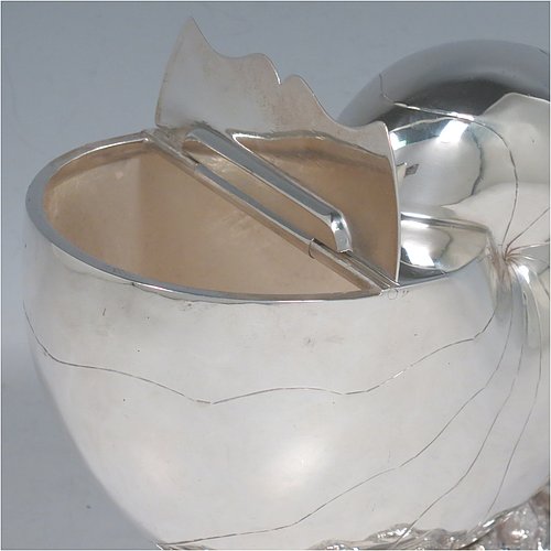An Antique Victorian Silver Plated spoon warmer, in the shape of a Nautilus shell, having a hand-chased body with invisibly hinged lid opening, and all sitting on a cast rock base with shell thumb-piece. Made by the Atkin Brothers of Sheffield in ca. 1880. The dimensions of this fine hand-made silver-plated spoon warmer are length 16.5 cms (6.5 inches), height 14 cms (5.5 inches), and width 9 cms (3.5 inches).