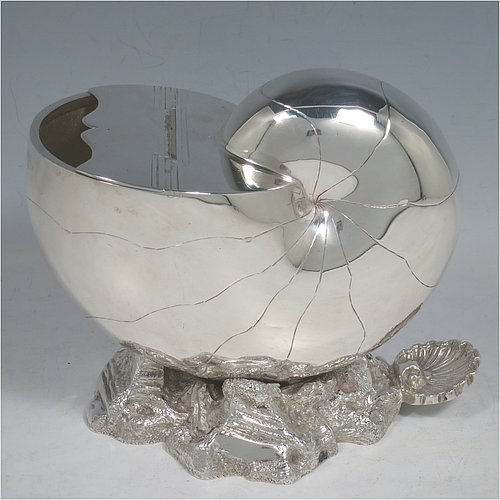 An Antique Victorian Silver Plated spoon warmer, in the shape of a Nautilus shell, having a hand-chased body with invisibly hinged lid opening, and all sitting on a cast rock base with shell thumb-piece. Made by the Atkin Brothers of Sheffield in ca. 1880. The dimensions of this fine hand-made silver-plated spoon warmer are length 16.5 cms (6.5 inches), height 14 cms (5.5 inches), and width 9 cms (3.5 inches).