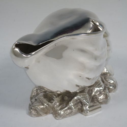 A handsome Antique Victorian Silver Plated spoon warmer, in the shape of a Conch shell, having a hand-chased body, and all sitting on a cast rock base with shells. Made in ca. 1880. The dimensions of this fine hand-made antique silver-plated spoon warmer are length 18 cms (7 inches), height 12 cms (4.75 inches), and width 10 cms (4 inches).