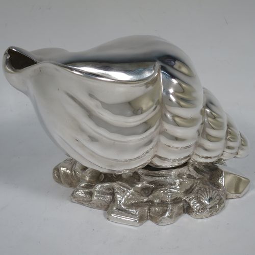 A handsome Antique Victorian Silver Plated spoon warmer, in the shape of a Conch shell, having a hand-chased body, and all sitting on a cast rock base with shells. Made in ca. 1880. The dimensions of this fine hand-made antique silver-plated spoon warmer are length 18 cms (7 inches), height 12 cms (4.75 inches), and width 10 cms (4 inches).