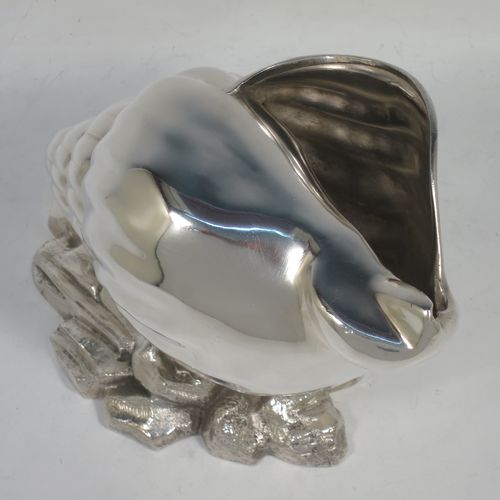 A handsome Antique Victorian Silver Plated spoon warmer, in the shape of a Conch shell, having a hand-chased body, and all sitting on a cast rock base with shells. Made in ca. 1880. The dimensions of this fine hand-made antique silver-plated spoon warmer are length 18 cms (7 inches), height 12 cms (4.75 inches), and width 10 cms (4 inches).