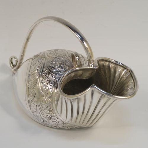 A beautiful and unusual Antique Victorian Silver Plated spoon warmer, in the shape of a fly trap pitcher plant, having a hand-chased body with fluted, leaf, and scroll decoration, and a scroll tendril handle. This pretty spoon warmer was made in ca. 1880 and has a design registration mark and a retailers mark for Glasgow. The dimensions of this fine hand-made antique silver-plated spoon warmer are length 20 cms (8 inches), height 10 cms (4 inches), and width 8.5 cms (3.3 inches).   