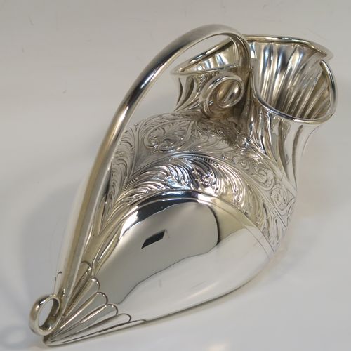 A beautiful and unusual Antique Victorian Silver Plated spoon warmer, in the shape of a fly trap pitcher plant, having a hand-chased body with fluted, leaf, and scroll decoration, and a scroll tendril handle. This pretty spoon warmer was made in ca. 1880 and has a design registration mark and a retailers mark for Glasgow. The dimensions of this fine hand-made antique silver-plated spoon warmer are length 20 cms (8 inches), height 10 cms (4 inches), and width 8.5 cms (3.3 inches).