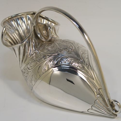 A beautiful and unusual Antique Victorian Silver Plated spoon warmer, in the shape of a fly trap pitcher plant, having a hand-chased body with fluted, leaf, and scroll decoration, and a scroll tendril handle. This pretty spoon warmer was made in ca. 1880 and has a design registration mark and a retailers mark for Glasgow. The dimensions of this fine hand-made antique silver-plated spoon warmer are length 20 cms (8 inches), height 10 cms (4 inches), and width 8.5 cms (3.3 inches).