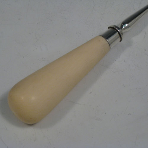 Antique Victorian sterling silver stilton cheese scoop, having a very plain body with hand-cut ivory handle, plain round ferrule, and plain shank with scoop. Made by Angel and Savoury of London in 1881. The dimensions of this fine hand-made silver stilton cheese scoop are length 23 cms (9 inches).