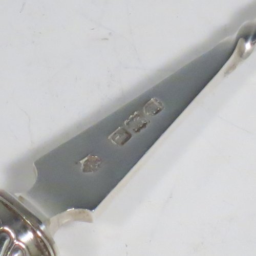 An Antique Victorian Sterling Silver and Ivory handled stilton cheese scoop, having a hand-cut spirally fluted handle, a hand-chased swirl-fluted ferrule, and a twisted stem with plain scoop. Made by William Hutton of London in 1899. The dimensions of this fine hand-made antique silver stilton cheese scoop are length 24 cms (9.5 inches).