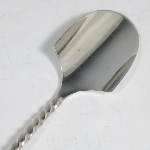 An Antique Victorian Sterling Silver and Ivory handled stilton cheese scoop, having a hand-cut spirally fluted handle, a hand-chased swirl-fluted ferrule, and a twisted stem with plain scoop. Made by William Hutton of London in 1899. The dimensions of this fine hand-made antique silver stilton cheese scoop are length 24 cms (9.5 inches).