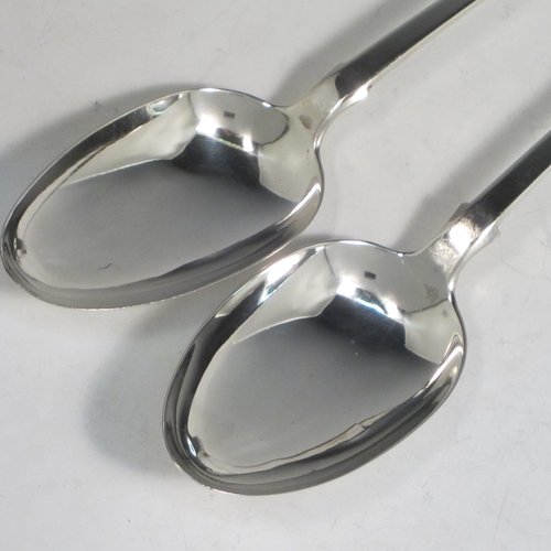 Antique late Georgian sterling silver pair of stuffing or basting spoons, in the Fiddle pattern, having plain oval pointed bowls, and plain long handles with pips on the reverse. Made by William Eley of London in 1830. The length of these fine hand-made silver basting / stuffing spoons is 30.5 cms (12 inches), and the total weight is approx. 224g (7.2 troy ounces).