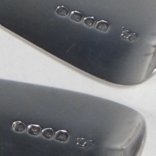 Antique late Georgian sterling silver pair of stuffing or basting spoons, in the Fiddle pattern, having plain oval pointed bowls, and plain long handles with pips on the reverse. Made by William Eley of London in 1830. The length of these fine hand-made silver basting / stuffing spoons is 30.5 cms (12 inches), and the total weight is approx. 224g (7.2 troy ounces).