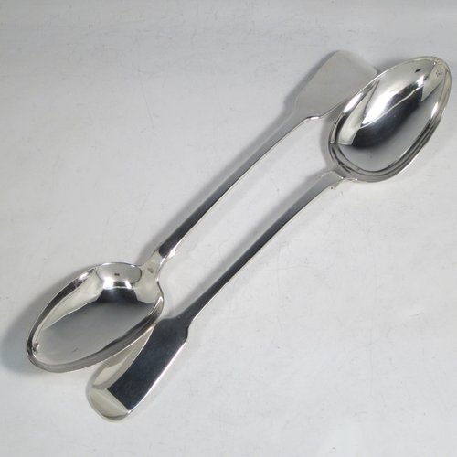 Antique late Georgian sterling silver pair of stuffing or basting spoons, in the Fiddle pattern, having plain oval pointed bowls, and plain long handles with pips on the reverse. Made by William Eley of London in 1830. The length of these fine hand-made silver basting / stuffing spoons is 30.5 cms (12 inches), and the total weight is approx. 224g (7.2 troy ounces).