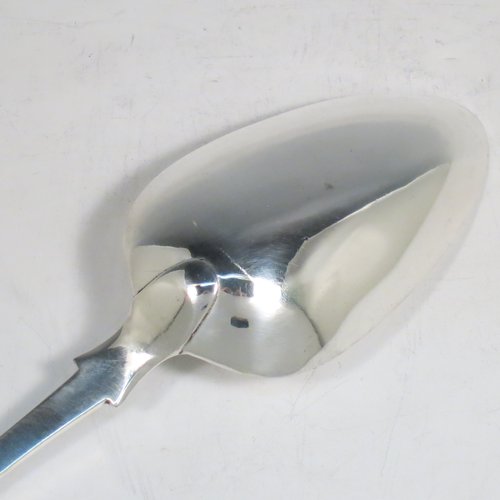 An Antique Georgian sterling silver Scottish Fiddle pattern stuffing spoon, having a very plain handle with pip on reverse, and a plain oval bowl. Made in Edinburgh in 1812. The dimensions of this fine hand-made antique silver stuffing spoon are length 31 cms (12.25 inches), and it weighs approx. 122g (4 troy ounces). Please note that this item is crested with Touch Not the Cat but a Glove for either the Mackpherson or Mackintosh clan.