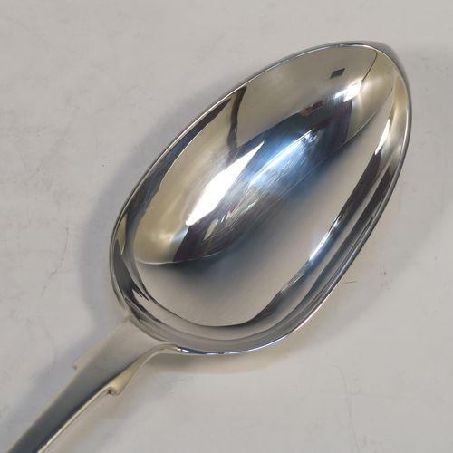 A handsome Antique Victorian Sterling Silver Fiddle pattern stuffing spoon, having a very plain handle with pip on reverse, and a plain oval bowl with shoulders above. This elegant antique silver serving spoon was made by Charles Boyton I of London in 1884. The dimensions of this fine hand-made antique silver stuffing spoon are length 31 cms (12.25 inches), and it weighs approx. 142g (4.6 troy ounces).  