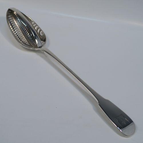 A rare and handsome Antique Georgian Sterling Silver   mutton strainer spoon, having a very plain Fiddle pattern handle with pip on reverse, and a plain oval bowl, attached to which is a vertical strainer section. This elegant silver serving and strainer spoon was made by William Eley and William Fern of London in 1805. The dimensions of this fine hand-made antique silver strainer spoon are length 30 cms (11.75 inches), and it weighs approx. 174g (5.6 troy ounces).   