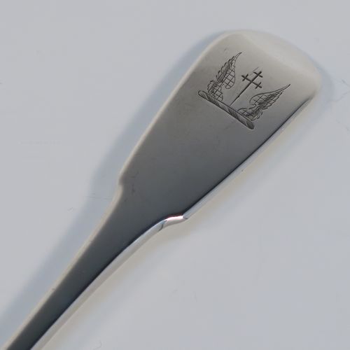 A rare and handsome Antique Georgian Sterling Silver   mutton strainer spoon, having a very plain Fiddle pattern handle with pip on reverse, and a plain oval bowl, attached to which is a vertical strainer section. This elegant silver serving and strainer spoon was made by William Eley and William Fern of London in 1805. The dimensions of this fine hand-made antique silver strainer spoon are length 30 cms (11.75 inches), and it weighs approx. 174g (5.6 troy ounces).   