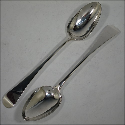 A very handsome pair of Antique Georgian Sterling Silver stuffing or serving spoons in the Old English pattern, having very plain handles with pips on reverse, and plain oval bowls. Made by Eley, Fearn, and Chawner of London in 1811. The dimensions of this fine hand-made pair of antique silver serving or stuffing spoons are length 26.5 cms (10.5 inches), and they have a total weight of approx. 195g (6.3 troy ounces).    