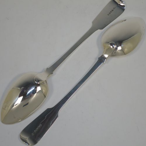 A very handsome pair of Antique Georgian Sterling Silver stuffing or serving spoons in the Fiddle pattern, having very plain handles with shoulders and pips on reverse, and plain oval bowls. Made by John Hawkins of London in 1831. The dimensions of this fine hand-made pair of antique silver serving or stuffing spoons are length 29 cms (11.5 inches), and they have a total weight of approx. 220g (7 troy ounces).