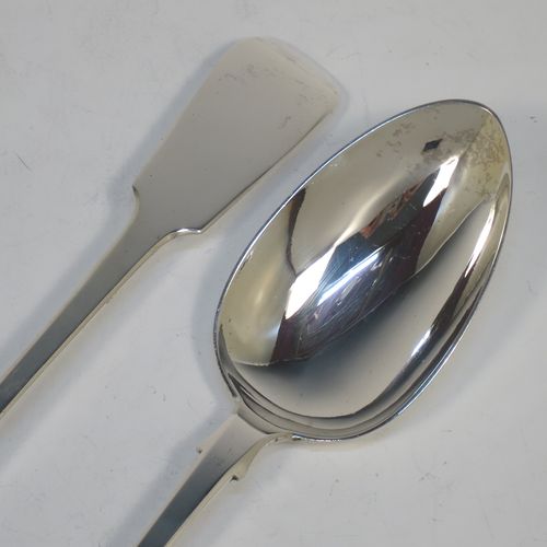 A very handsome pair of Antique Georgian Sterling Silver stuffing or serving spoons in the Fiddle pattern, having very plain handles with shoulders and pips on reverse, and plain oval bowls. Made by John Hawkins of London in 1831. The dimensions of this fine hand-made pair of antique silver serving or stuffing spoons are length 29 cms (11.5 inches), and they have a total weight of approx. 220g (7 troy ounces).