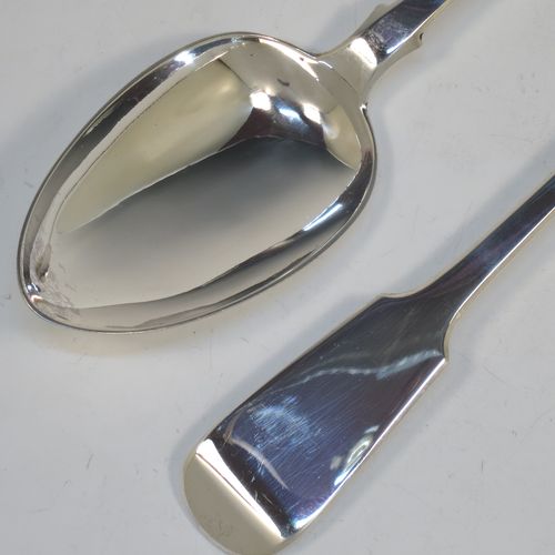 A very handsome pair of Antique Georgian Sterling Silver stuffing or serving spoons in the Fiddle pattern, having very plain handles with shoulders and pips on reverse, and plain oval bowls. Made by John Hawkins of London in 1831. The dimensions of this fine hand-made pair of antique silver serving or stuffing spoons are length 29 cms (11.5 inches), and they have a total weight of approx. 220g (7 troy ounces).
