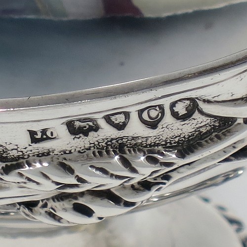 A very pretty Antique Victorian Sterling Silver sugar basket, having an oval shaped body, a swing-handle, and sitting on a pedestal foot, all hand-chased with floral and fruit decoration. Made by Jacobes J. Oasterbaan of London in 1878. The dimensions of this fine hand-made antique silver sugar basket are height 12.5 cms (5 inches), length 11.5 cms (4.5 inches), width 9 cms (3.5 inches), and it weighs approx. 192g (6.2 troy ounces).