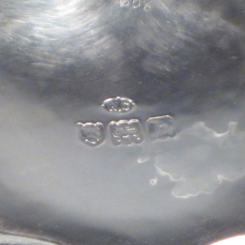 Antique Edwardian sterling silver Arts and Crafts style sugar bowl, having a round body with hand-chased lobed decoration, a hand-hammered finish, and sitting on a flat base. Made by William Comyns of London in 1903. The dimensions of this fine hand-made silver sugar bowl are height 5 cms (2 inches), diameter 10 cms (4 inches), and it weighs approx. 150g (4.8 troy ounces).