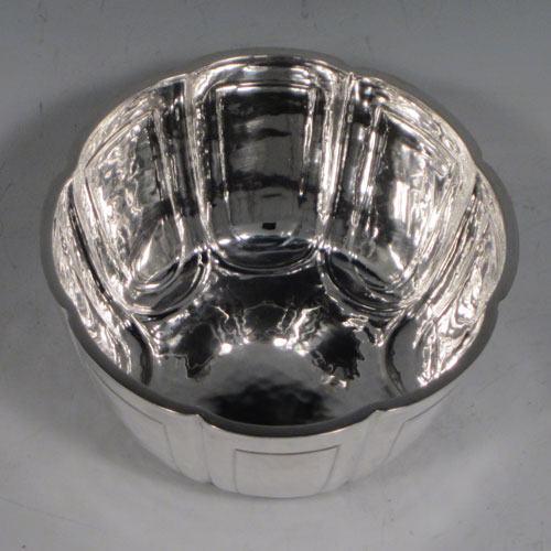 Antique Edwardian sterling silver Arts and Crafts style sugar bowl, having a round body with hand-chased lobed decoration, a hand-hammered finish, and sitting on a flat base. Made by William Comyns of London in 1903. The dimensions of this fine hand-made silver sugar bowl are height 5 cms (2 inches), diameter 10 cms (4 inches), and it weighs approx. 150g (4.8 troy ounces).