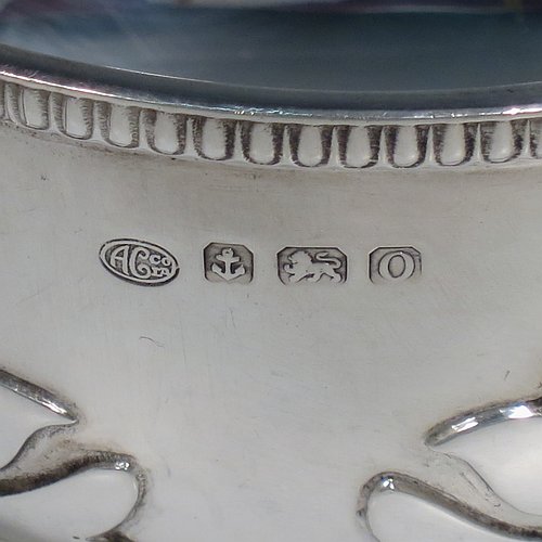 An Antique Sterling Silver sugar bowl, in a Georgian style, having a round bellied body, with unusual applied cut-card work and a gadroon border, two scroll side-handles, and all sitting on a pedestal foot. Made by Alexander Clarke & Co., of Birmingham 1913. The dimensions of this fine hand-made silver sugar bowl are height 7 cms (2.75 inches), spread across handles 15 cms (6 inches), and it weighs approx. 233g (7.5 troy ounces).    