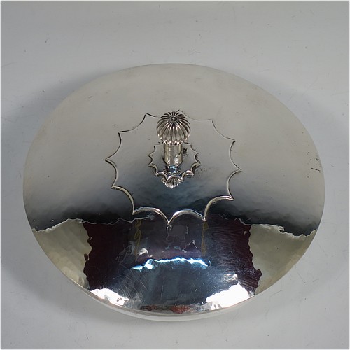 A very handsome Arts and Crafts style covered sugar bowl, having a round body with hand-hammered decoration and applied reeded borders, a lift-off lid with cast ball finial and applied strap-work sun-star decoration, and all sitting on a collet foot. Made by the Rotherham School of Art of Sheffield in 1950. The dimensions of this fine hand-made silver sugar bowl and cover are height 10 cms (4 inches), diameter 14.5 cms (5.75 inches), and it weighs approx. 450g (14.5 troy ounces).   