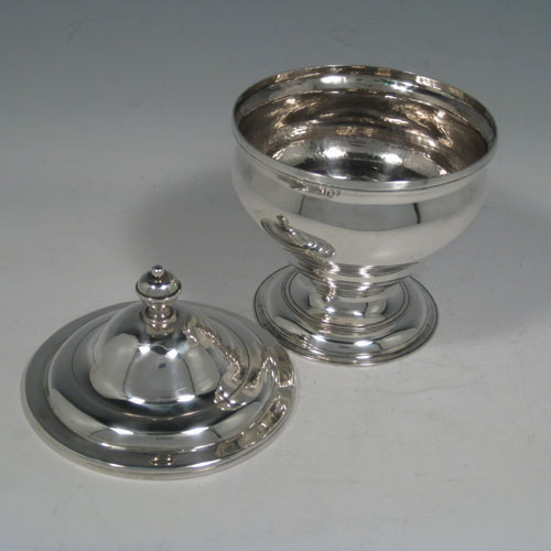 Antique Georgian sterling silver covered sugar or sweetmeat bowl, having a plain round baluster body, applied reeded borders, a pull-off lid with finial, and sitting on a pedestal foot. Made by William Cafe of London in 1761. The dimensions of this fine hand-made silver covered sugar / sweetmeat bowl are height 15 cms (6 inches), diameter 11 cms (4.25 inches), and it has a total weight of approx. 331g (10.7 troy ounces).   