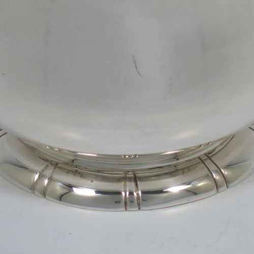 A very elegant and heavy Sterling Silver sugar bowl, having a plain round bellied body, with an applied top reeded border, and all sitting on a pedestal foot with hand-chased fluted decoration. Made by George Tarratt of London in 1971. The dimensions of this fine hand-made silver sugar bowl are height 8 cms (3 inches), diameter at lip 9 cms (3.5 inches), and it weighs approx. 244g (7.9 troy ounces).   