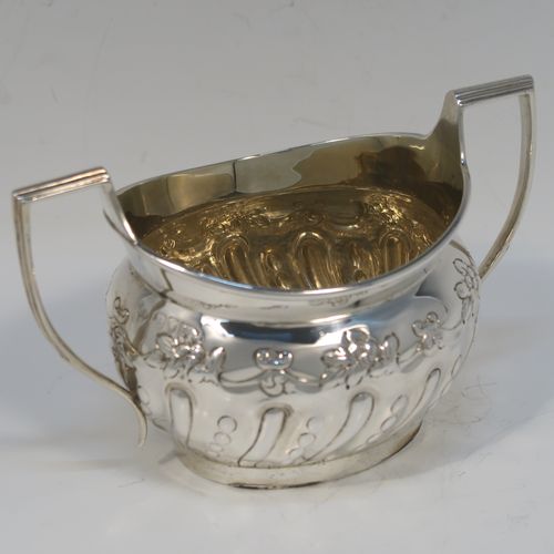 A very pretty Antique Victorian Sterling Silver sugar bowl, having an oval bellied body, with hand-chased half-fluted and floral decoration, two scroll side-handles, a gold-gilt interior, and all sitting on a collet foot. This beautiful silver sugar bowl was made by Charles Stuart Harris of London in 1895. The dimensions of this fine hand-made antique silver sugar bowl are length (inc. handles) 15 cms (6 inches), height 9 cms (3.5 inches), width 9 cms (3.5 inches), and it weighs approx. 198g (6.4 troy ounces).   