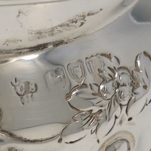 A very pretty Antique Victorian Sterling Silver sugar bowl, having an oval bellied body, with hand-chased half-fluted and floral decoration, two scroll side-handles, a gold-gilt interior, and all sitting on a collet foot. This beautiful silver sugar bowl was made by Charles Stuart Harris of London in 1895. The dimensions of this fine hand-made antique silver sugar bowl are length (inc. handles) 15 cms (6 inches), height 9 cms (3.5 inches), width 9 cms (3.5 inches), and it weighs approx. 198g (6.4 troy ounces).   