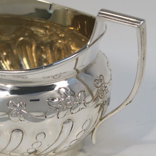A very pretty Antique Victorian Sterling Silver sugar bowl, having an oval bellied body, with hand-chased half-fluted and floral decoration, two scroll side-handles, a gold-gilt interior, and all sitting on a collet foot. This beautiful silver sugar bowl was made by Charles Stuart Harris of London in 1895. The dimensions of this fine hand-made antique silver sugar bowl are length (inc. handles) 15 cms (6 inches), height 9 cms (3.5 inches), width 9 cms (3.5 inches), and it weighs approx. 198g (6.4 troy ounces).   