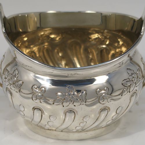 A very pretty Antique Victorian Sterling Silver sugar bowl, having an oval bellied body, with hand-chased half-fluted and floral decoration, two scroll side-handles, a gold-gilt interior, and all sitting on a collet foot. This beautiful silver sugar bowl was made by Charles Stuart Harris of London in 1895. The dimensions of this fine hand-made antique silver sugar bowl are length (inc. handles) 15 cms (6 inches), height 9 cms (3.5 inches), width 9 cms (3.5 inches), and it weighs approx. 198g (6.4 troy ounces).   