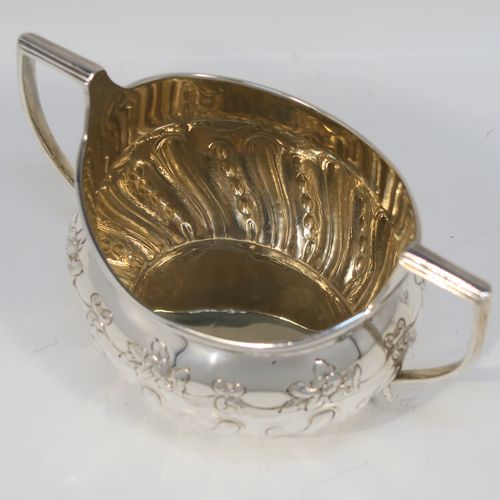 A very pretty Antique Victorian Sterling Silver sugar bowl, having an oval bellied body, with hand-chased half-fluted and floral decoration, two scroll side-handles, a gold-gilt interior, and all sitting on a collet foot. This beautiful silver sugar bowl was made by Charles Stuart Harris of London in 1895. The dimensions of this fine hand-made antique silver sugar bowl are length (inc. handles) 15 cms (6 inches), height 9 cms (3.5 inches), width 9 cms (3.5 inches), and it weighs approx. 198g (6.4 troy ounces).   
