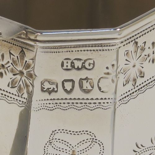 A very pretty Antique Victorian Sterling Silver sugar and creamer set, having octagonal panelled bodies with straight sides and hand-engraved floral decoration, with applied reeded borders, scoll sider handles, and all sitting on flat bases. This beautiful sugar and cream set was made by Henry William Curry of London in 1882. The dimensions of this fine hand-made antique silver cream and sugar set are height of creamer 9.5 cms (3.75 inches), length of sugar bowl 16.5 cms (6.5 inches), and with a total weight approx. 336g (10.8 troy ounces).