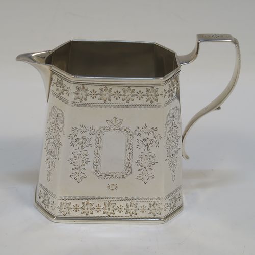 A very pretty Antique Victorian Sterling Silver sugar and creamer set, having octagonal panelled bodies with straight sides and hand-engraved floral decoration, with applied reeded borders, scoll sider handles, and all sitting on flat bases. This beautiful sugar and cream set was made by Henry William Curry of London in 1882. The dimensions of this fine hand-made antique silver cream and sugar set are height of creamer 9.5 cms (3.75 inches), length of sugar bowl 16.5 cms (6.5 inches), and with a total weight approx. 336g (10.8 troy ounces).