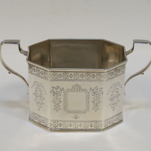 A very pretty Antique Victorian Sterling Silver sugar and creamer set, having octagonal panelled bodies with straight sides and hand-engraved floral decoration, with applied reeded borders, scoll sider handles, and all sitting on flat bases. This beautiful sugar and cream set was made by Henry William Curry of London in 1882. The dimensions of this fine hand-made antique silver cream and sugar set are height of creamer 9.5 cms (3.75 inches), length of sugar bowl 16.5 cms (6.5 inches), and with a total weight approx. 336g (10.8 troy ounces).