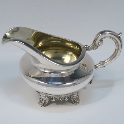 A very elegant Antique Victorian Sterling Silver sugar and creamer set, having plain round bellied bodies, with gold-gilt interiors and scroll handles, and all sitting on four scroll and shell feet. This handsome silver sugar and cream set was made by Benoni Stephens of London in 1861. The dimensions of this fine hand-made antique silver cream jug and sugar bowl set are height of cream jug 10 cms (4 inches), diameter of sugar bowl 14 cms (5.5 inches), and the total weight is approx. 593g (19 troy ounces).

   