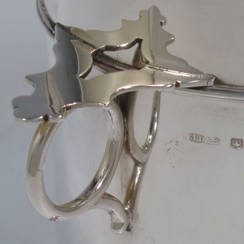 A very handsome Sterling Silver syphon stand, having a plain round body with straight sides, two ring side-handles with flat thumb-pieces, applied reeded borders and upper girdle, and sitting on a flat wood-turned coaster base. Made by James Dixon and Sons of Sheffield in 1933. The dimensions of this fine hand-made silver siphon stand are diameter 12 cms (4.75 inches), height 17 cms (6.75 inches), and it weighs approx. 450g (14.5 troy ounces).