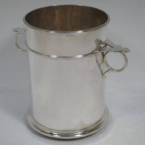 A very handsome Sterling Silver syphon stand, having a plain round body with straight sides, two ring side-handles with flat thumb-pieces, applied reeded borders and upper girdle, and sitting on a flat wood-turned coaster base. Made by James Dixon and Sons of Sheffield in 1933. The dimensions of this fine hand-made silver siphon stand are diameter 12 cms (4.75 inches), height 17 cms (6.75 inches), and it weighs approx. 450g (14.5 troy ounces).