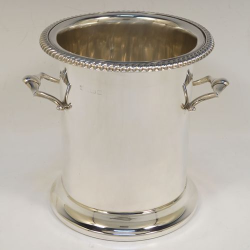 A very handsome Sterling Silver syphon stand, having a plain round body with straight sides, two cast scroll side-handles, an applied gadroon top border, and sitting on a collet foot. This elegant silver siphon stand was made by the Barker Brothers of Birmingham in 1932. The dimensions of this fine hand-made silver siphon stand are internal diameter 11.5 cms (4.5 inches), height 16 cms (6.3 inches), and it weighs approx. 616g (19.9 troy ounces).  