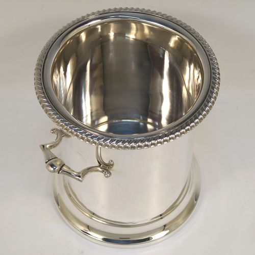 A very handsome Sterling Silver syphon stand, having a plain round body with straight sides, two cast scroll side-handles, an applied gadroon top border, and sitting on a collet foot. This elegant silver siphon stand was made by the Barker Brothers of Birmingham in 1932. The dimensions of this fine hand-made silver siphon stand are internal diameter 11.5 cms (4.5 inches), height 16 cms (6.3 inches), and it weighs approx. 616g (19.9 troy ounces).  