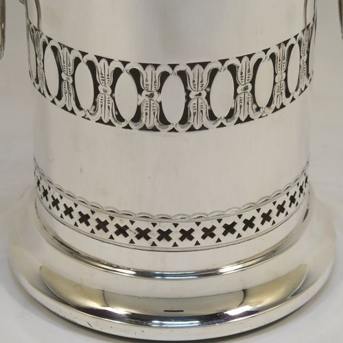 A very pretty Antique Sterling Silver syphon stand, having a round body with straight sides and hand-pierced decoration, with two cast lion-mask ring side-handles, an applied bead-edged top border, and all sitting on a pedestal foot. This elegant silver siphon stand was made by Richard Burbridge of Sheffield for Harrods in 1913. The dimensions of this fine hand-made silver siphon stand are internal diameter 10 cms (4 inches), height 16.5 cms (6.5 inches), and it weighs approx. 450g (14.5 troy ounces).