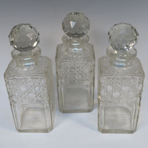 A very handsome Antique Silver-plated and wood framed three-bottle tantalus, with original hand-cut crystal decanters and stoppers, all in an oak (poss.) wooden frame with silver-plated and nickel pinned mounts, with a patented lock mechanism and key. The presentation inscription is engraved onto a sterling silver plaque with hallmarks, which indicate that this beautiful antique silver-plated and wood tantalus was made by Walker and Hall of Birmingham in 1912. The dimensions of this fine hand-made antique three-bottle tantalus are length 36 cms (14 inches), height 32 cms (12.5 inches), and depth 14 cms (5.5 inches).