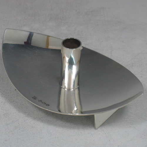 Pair of sterling silver 'Modernistic' tapersticks made by Cooper Brothers & Sons Ltd., of Sheffield in 1965. Length 12 cms, width 8 cms. Weight 6.5 troy ounces.