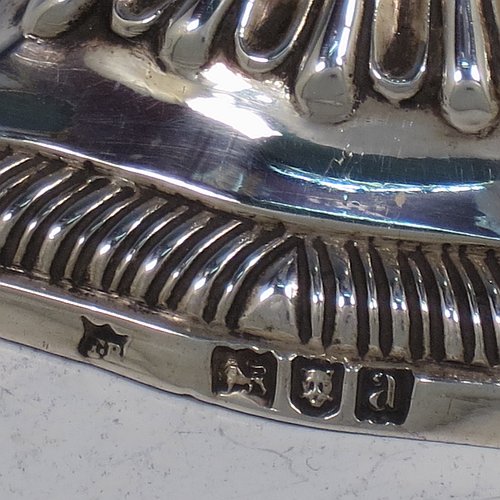A very pretty Antique Victorian cast sterling silver taper-stick, having shaped gadroon borders, and hand-chased fluted decoration, with a removable nozzle. All made by Turner Bradbury of London in 1896. The dimensions of this fine hand-made antique silver taper-stick are height 12 cms (4.75 inches), and it weighs approx. 146g (4.7 troy ounces).